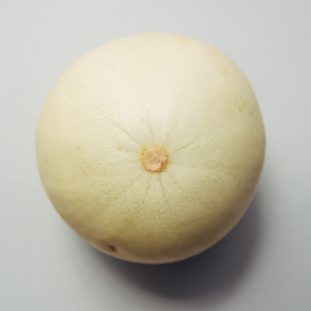 round brown fruit placed on white surface